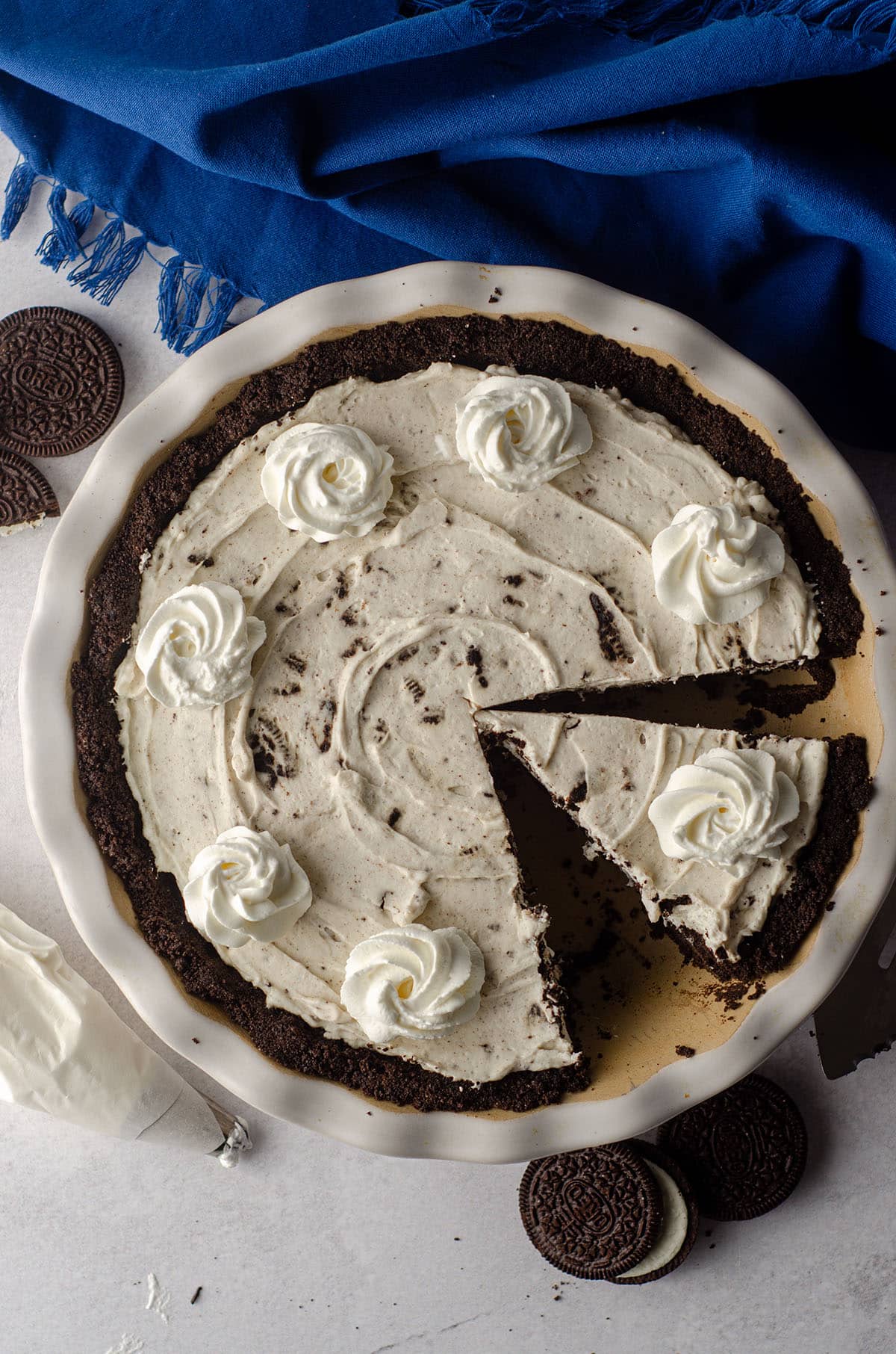 aerial photo of no bake oreo pie sliced and in a pie plate ready to serve