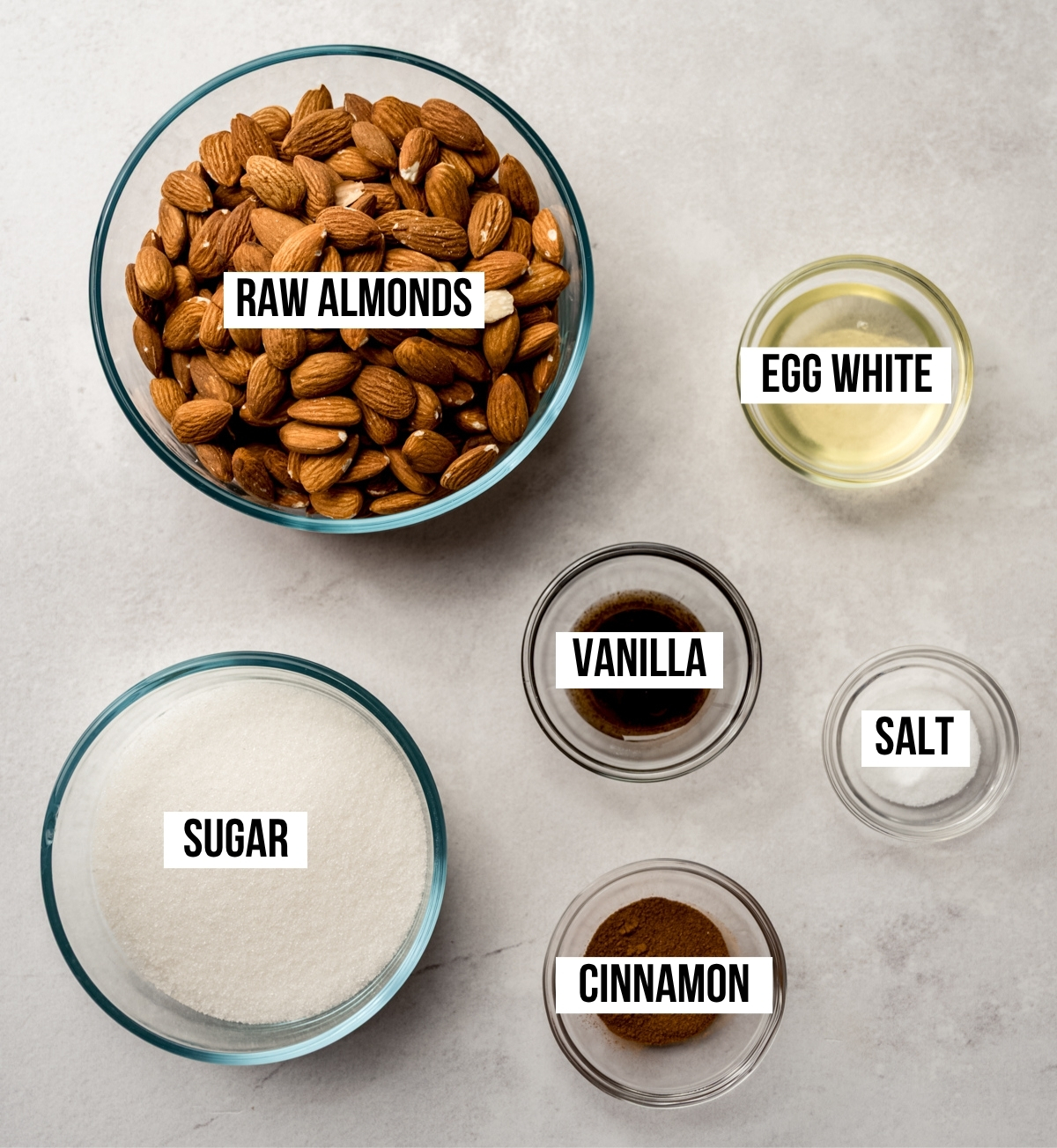 Aerial photo of ingredients to make candied almonds with text overlay labeling each ingredient.