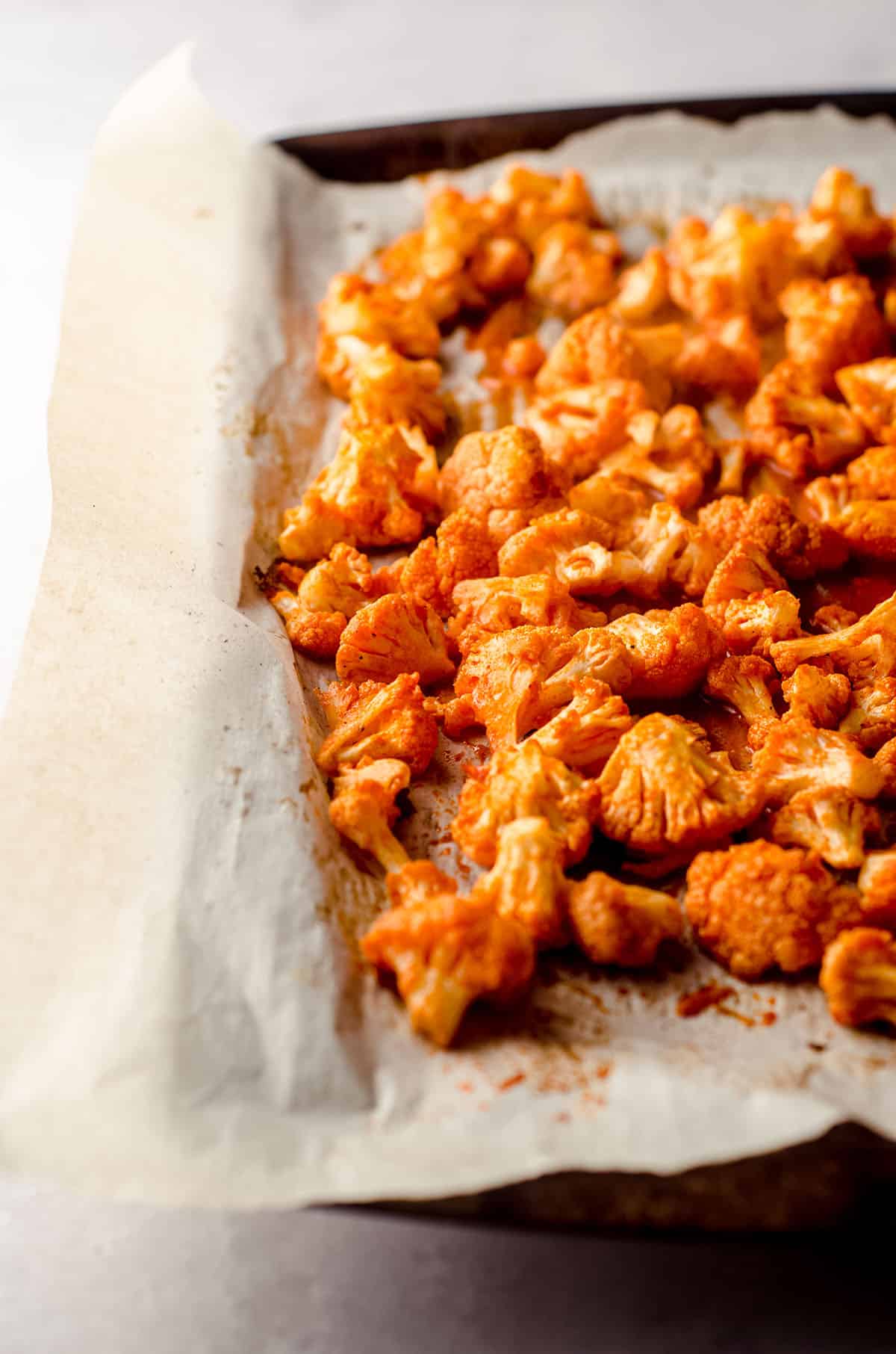 oven baked cauliflower covered in hot sauce to make the filling for buffalo cauliflower tacos