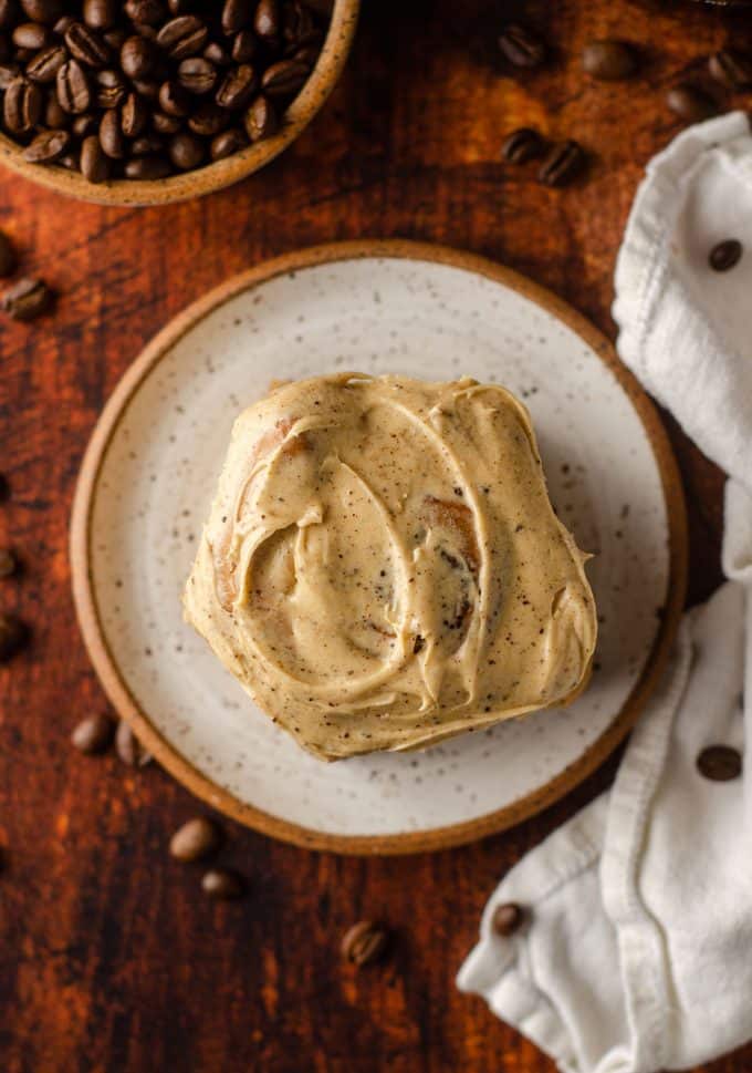 aerial photo of coffee cinnamon roll on a white plate