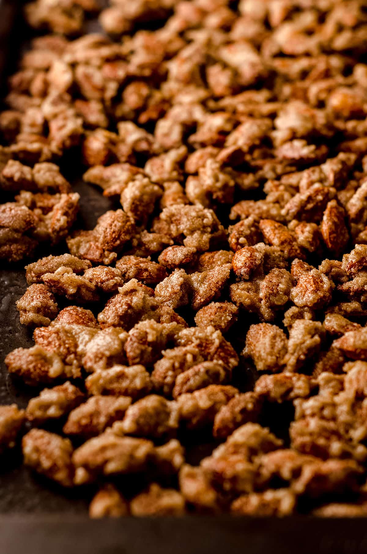 candied almonds on a baking sheet before baking