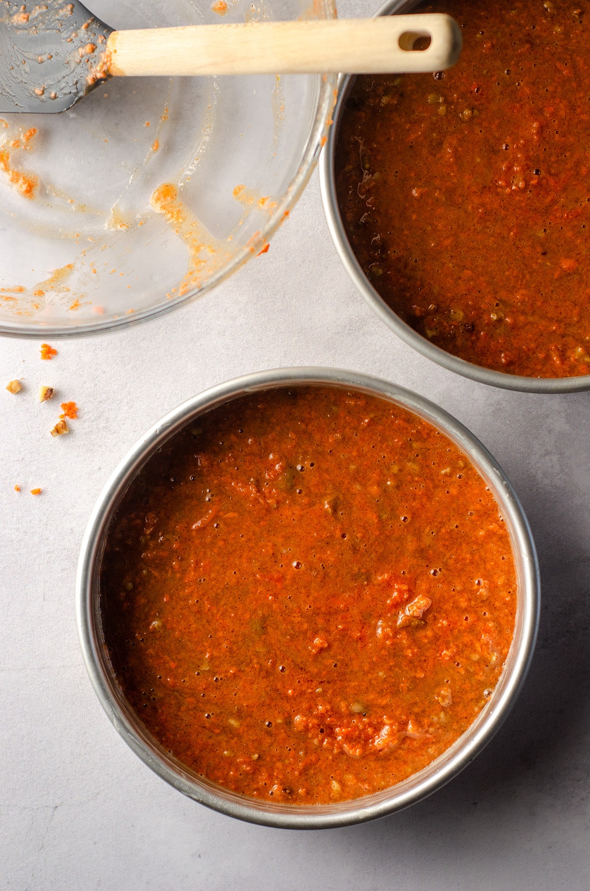 aerial photo of carrot walnut cake batter in baking pans