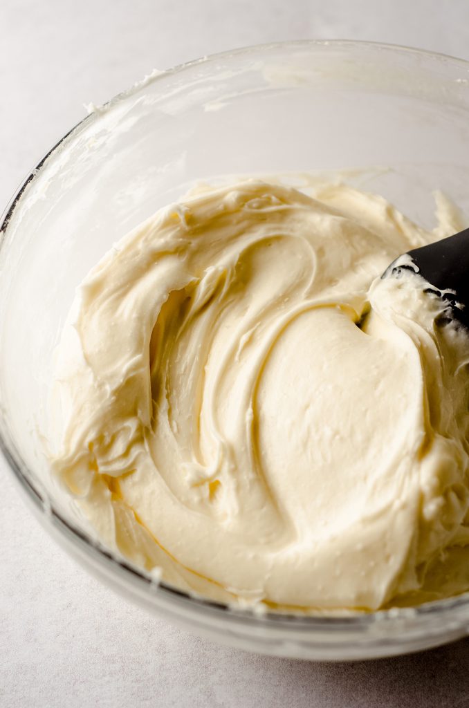 cream cheese frosting in a glass bowl