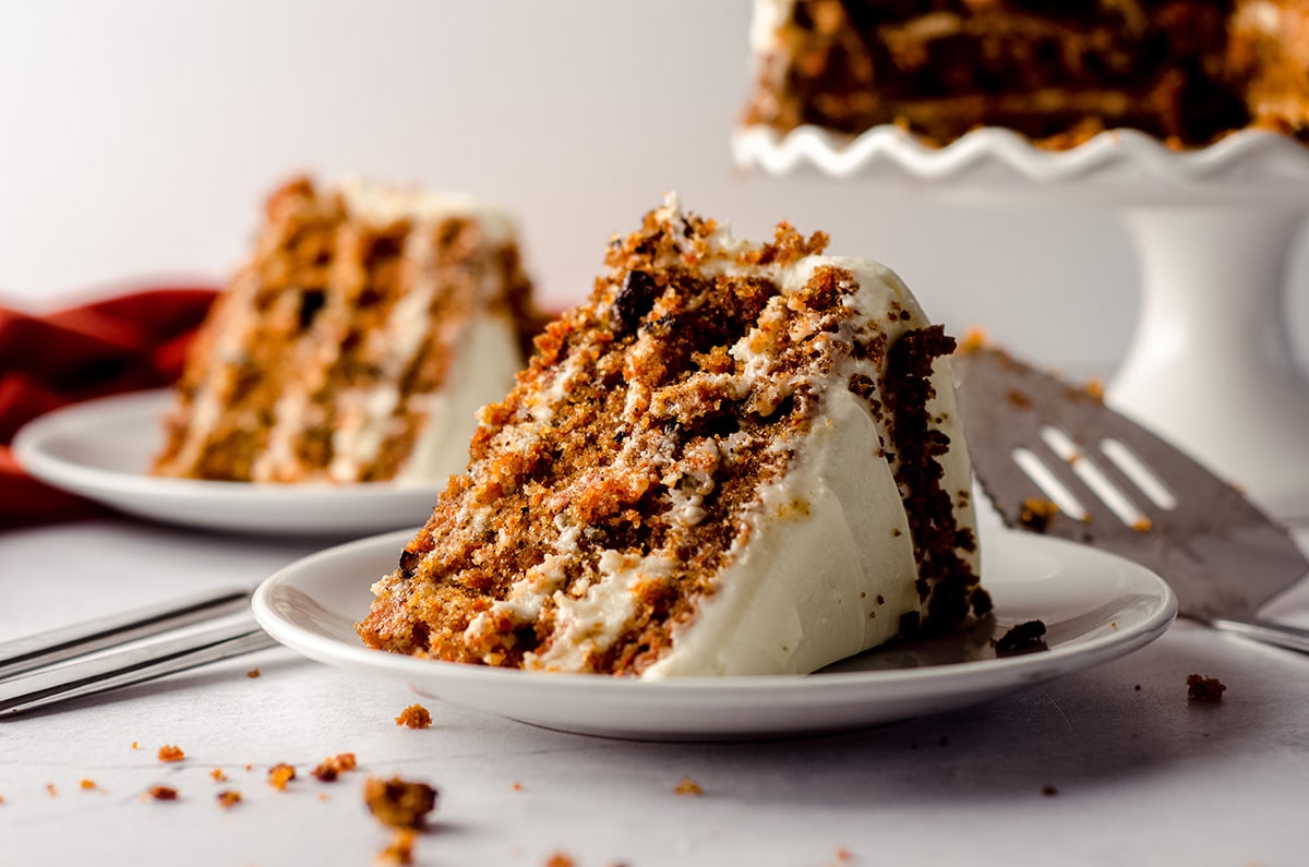 slice of carrot walnut cake on a white plate