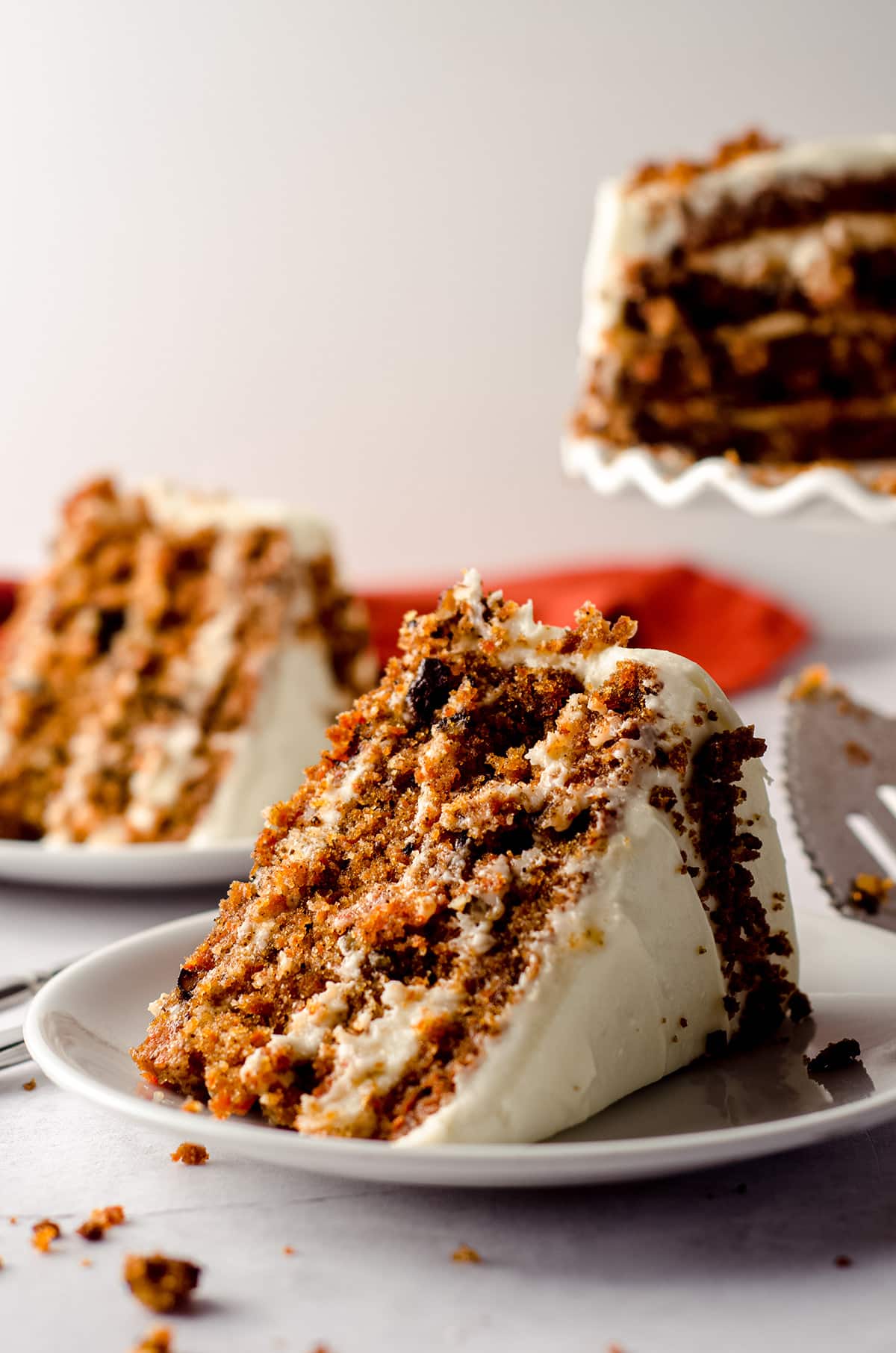 slice of carrot walnut cake on a white plate
