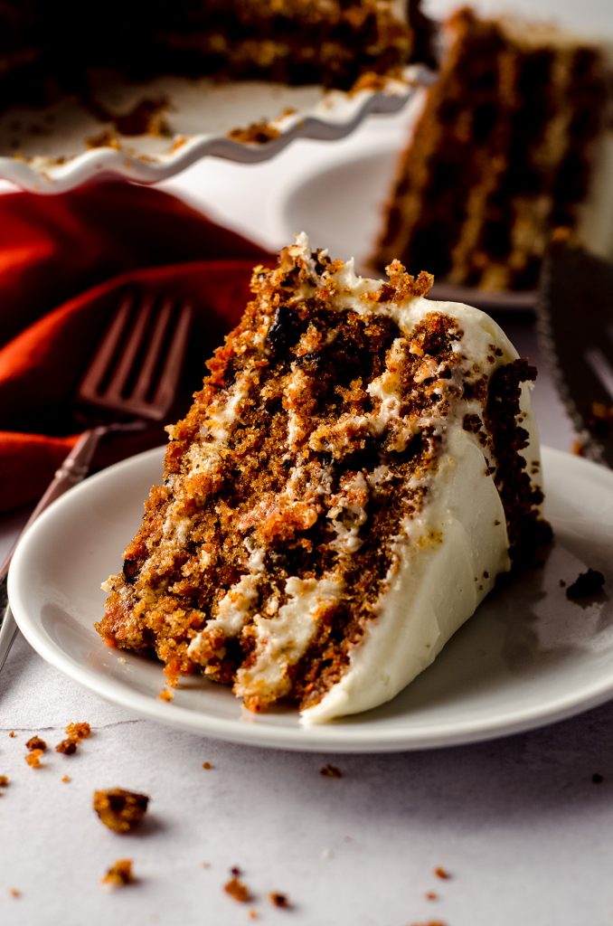 slice of carrot walnut cake on a white plate