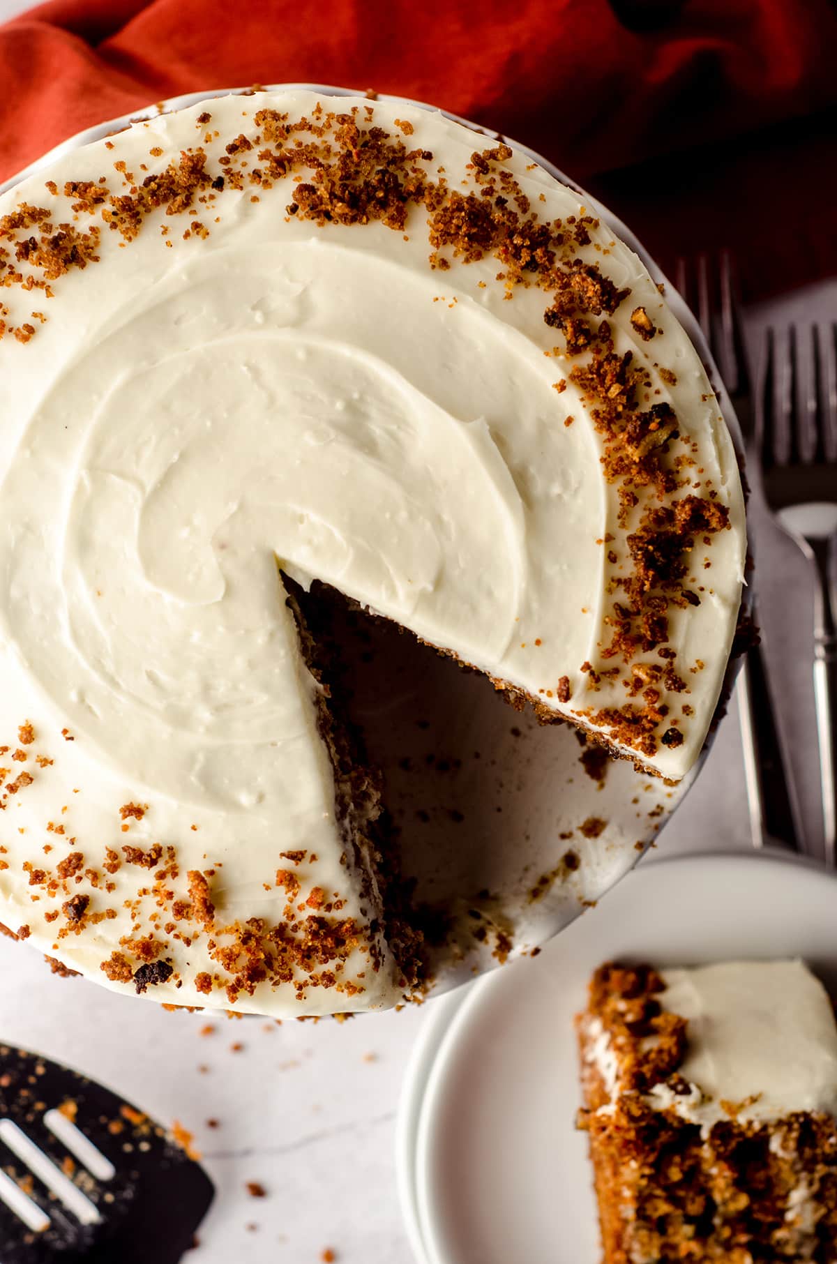 aerial photo of a carrot walnut cake with a slice taken out of it