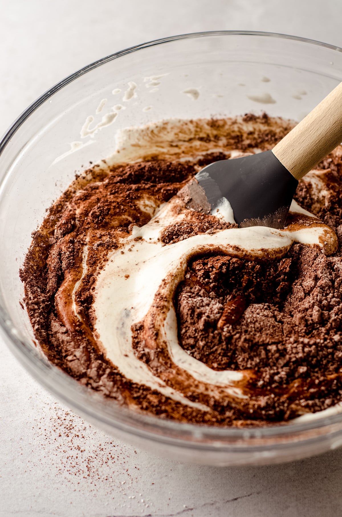 folding cocoa powder and powdered sugar into whipped cream to make easy chocolate mousse