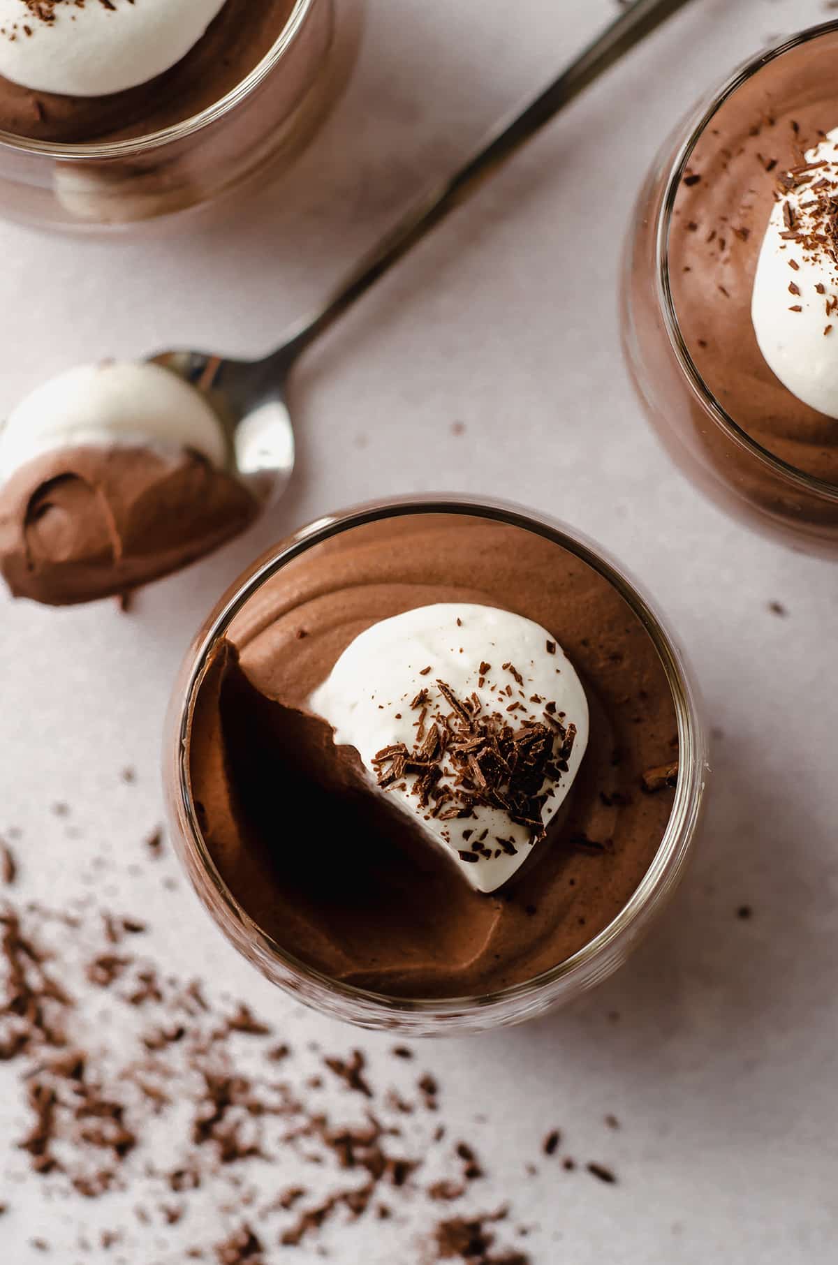 dessert cup of chocolate mousse with a scoop taken out of it