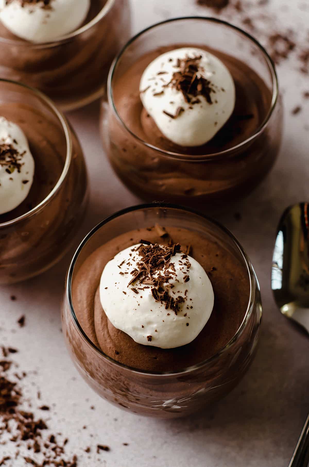 dessert cups filled with easy chocolate mousse topped with whipped cream and shaved chocolate