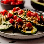 taco zucchini boats on a plate with a fork and a knife