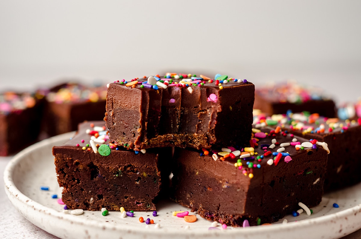 stack of funfetti brownies with a bite taken out of one of them