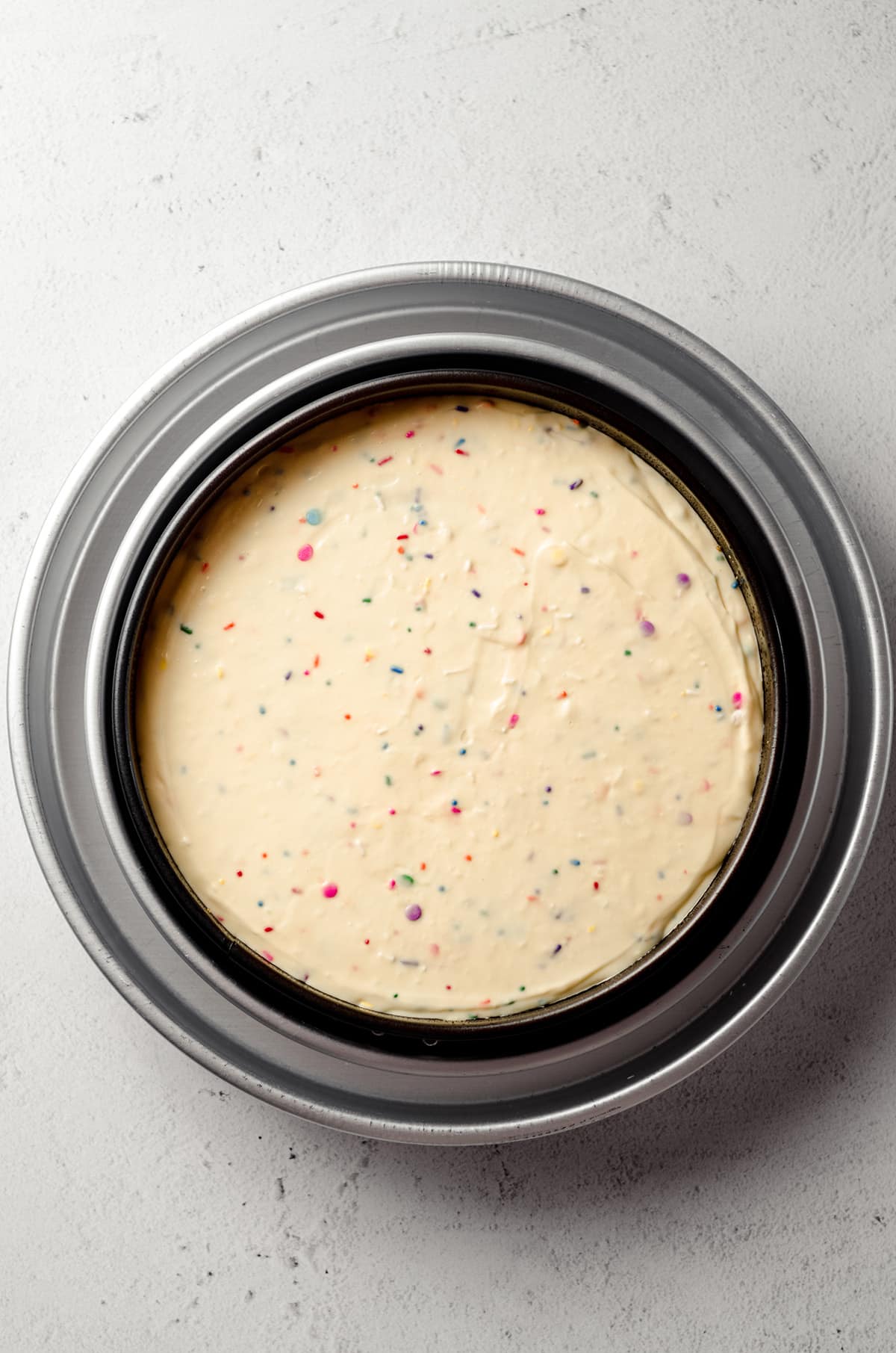funfetti cheesecake in a springform pan ready to bake