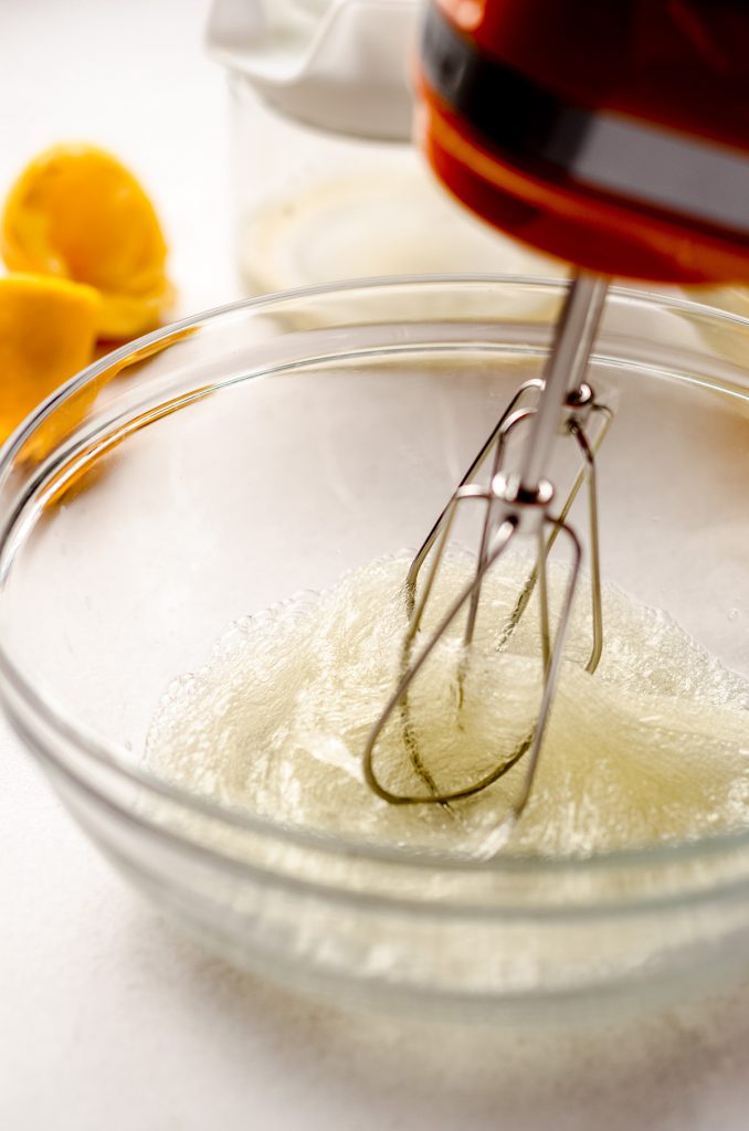 whipping egg whites in glass bowl