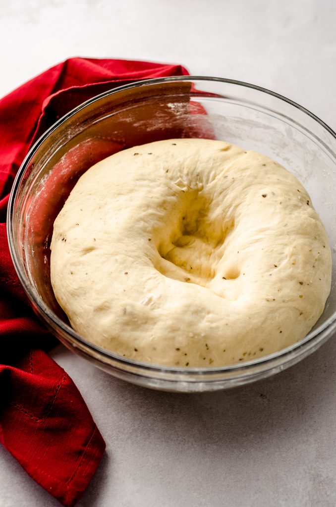 pizza pull apart bread dough that has been punched down in a glass bowl
