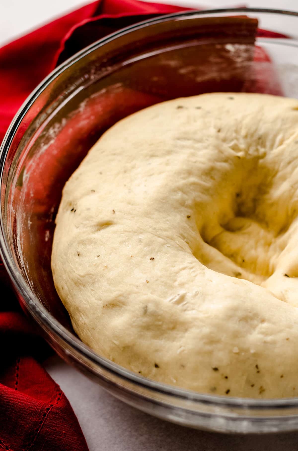 pizza pull apart bread dough that has been punched down in a glass bowl