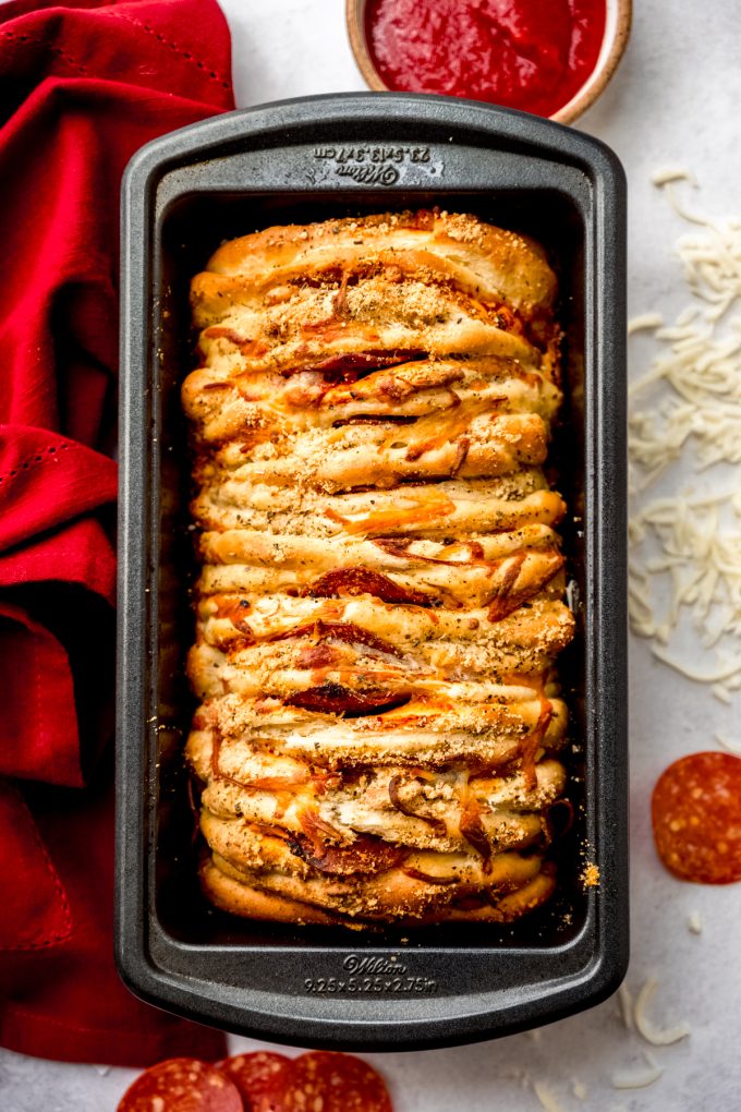 Aerial photo of pizza pull-apart bread in a loaf pan.