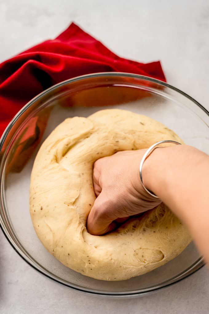 Someone is punching down a ball of risen yeasted dough.