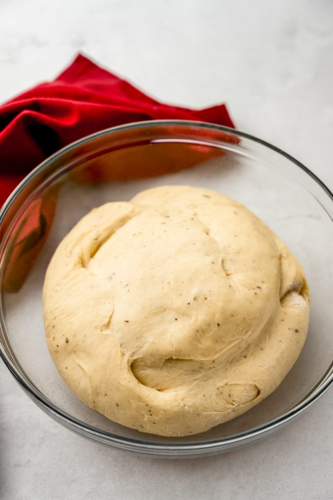 A ball of yeasted dough in a bowl after rising.
