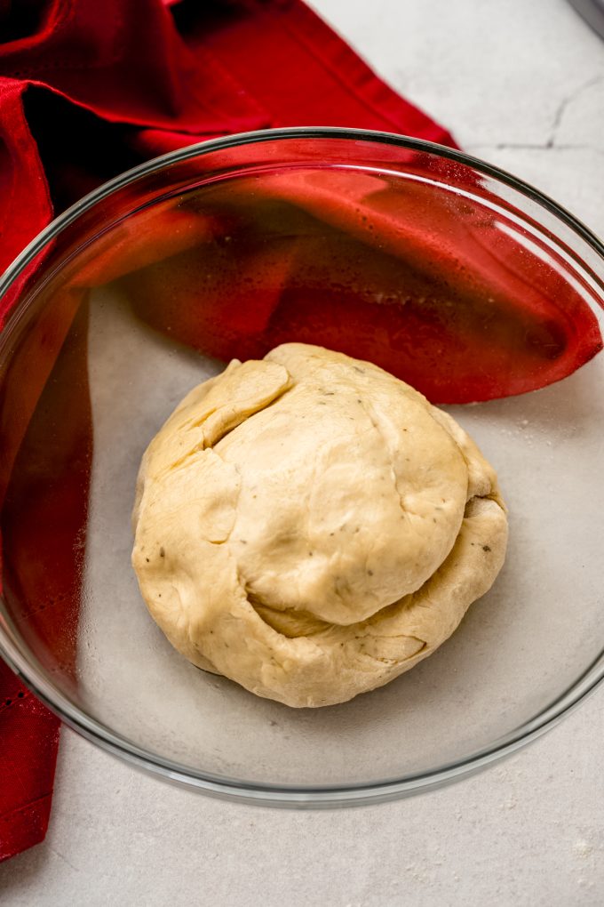 A ball of yeasted dough in a bowl before rising.