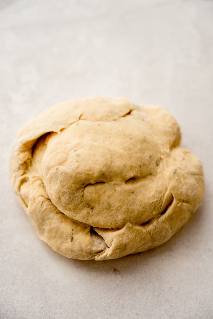 A ball of yeast dough on a surface.