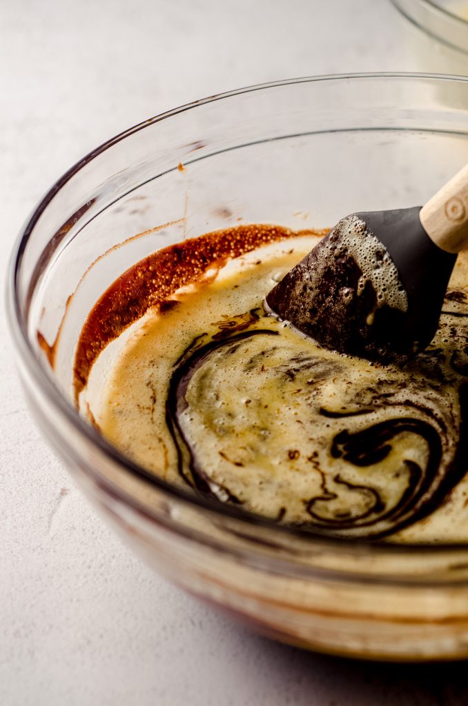 stirring eggs into melted chocolate