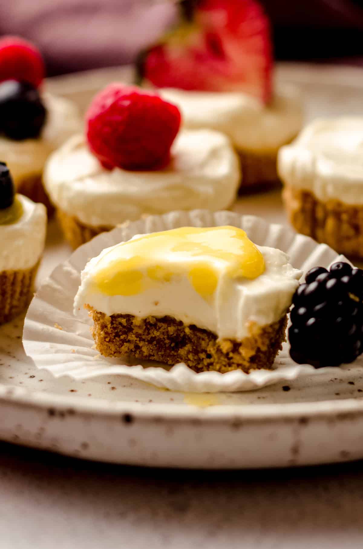 an unwrapped no bake cheesecake bite with lemon curd on top