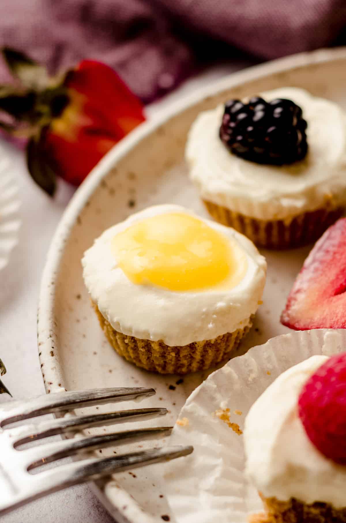 no bake cheesecake bites on a plate topped with lemon curd