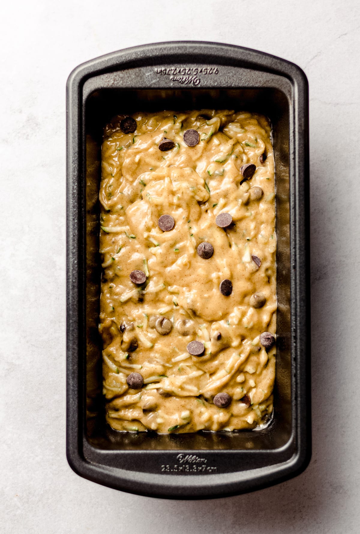 chocolate chip zucchini bread batter in a loaf pan