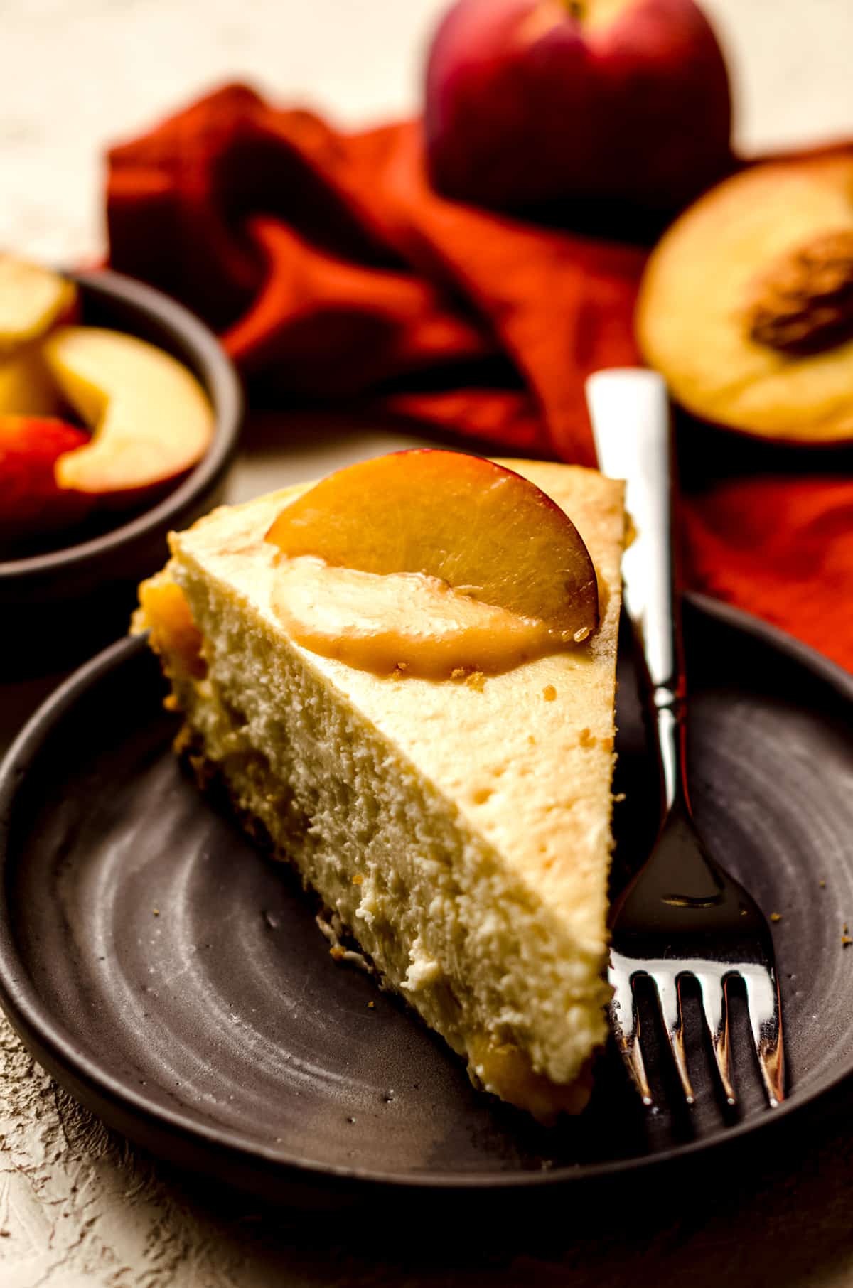 slice of peach cheesecake on a plate