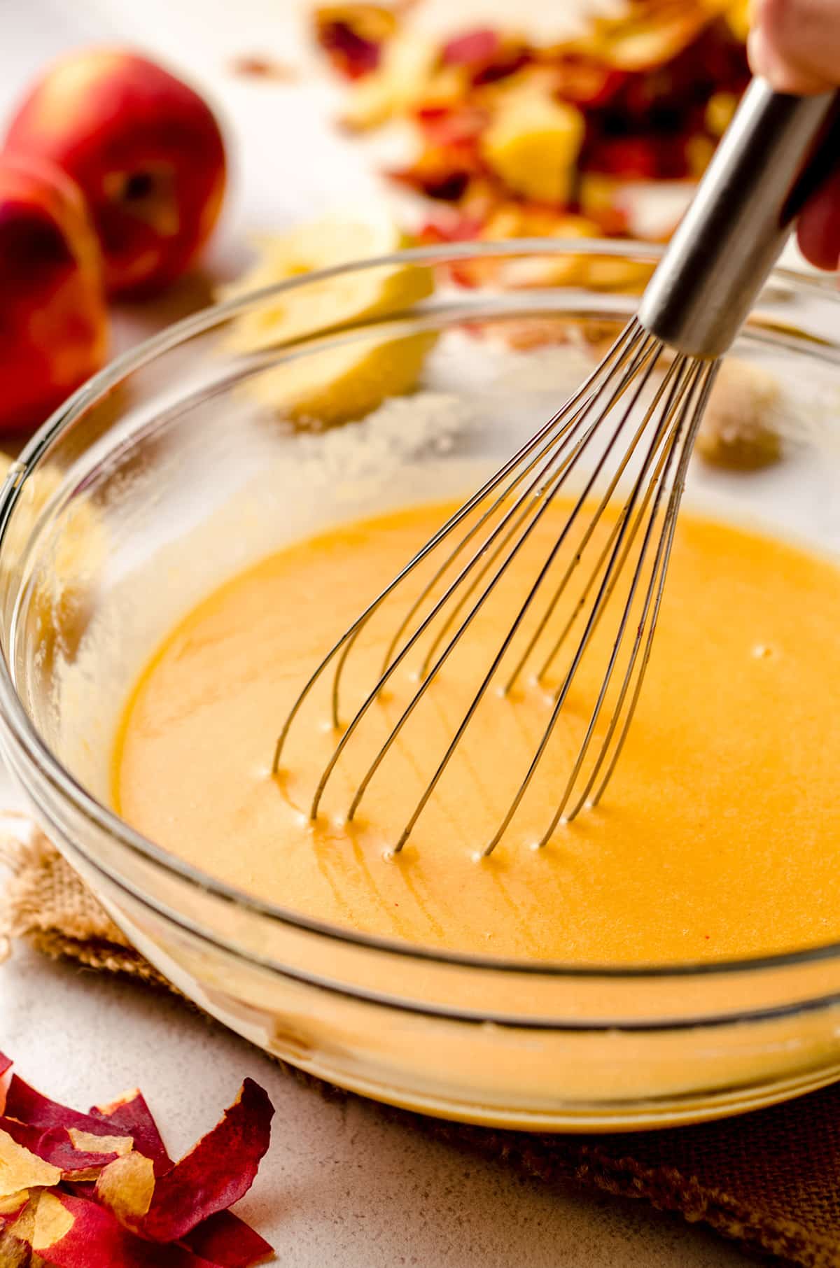 whisking butter into homemade peach curd