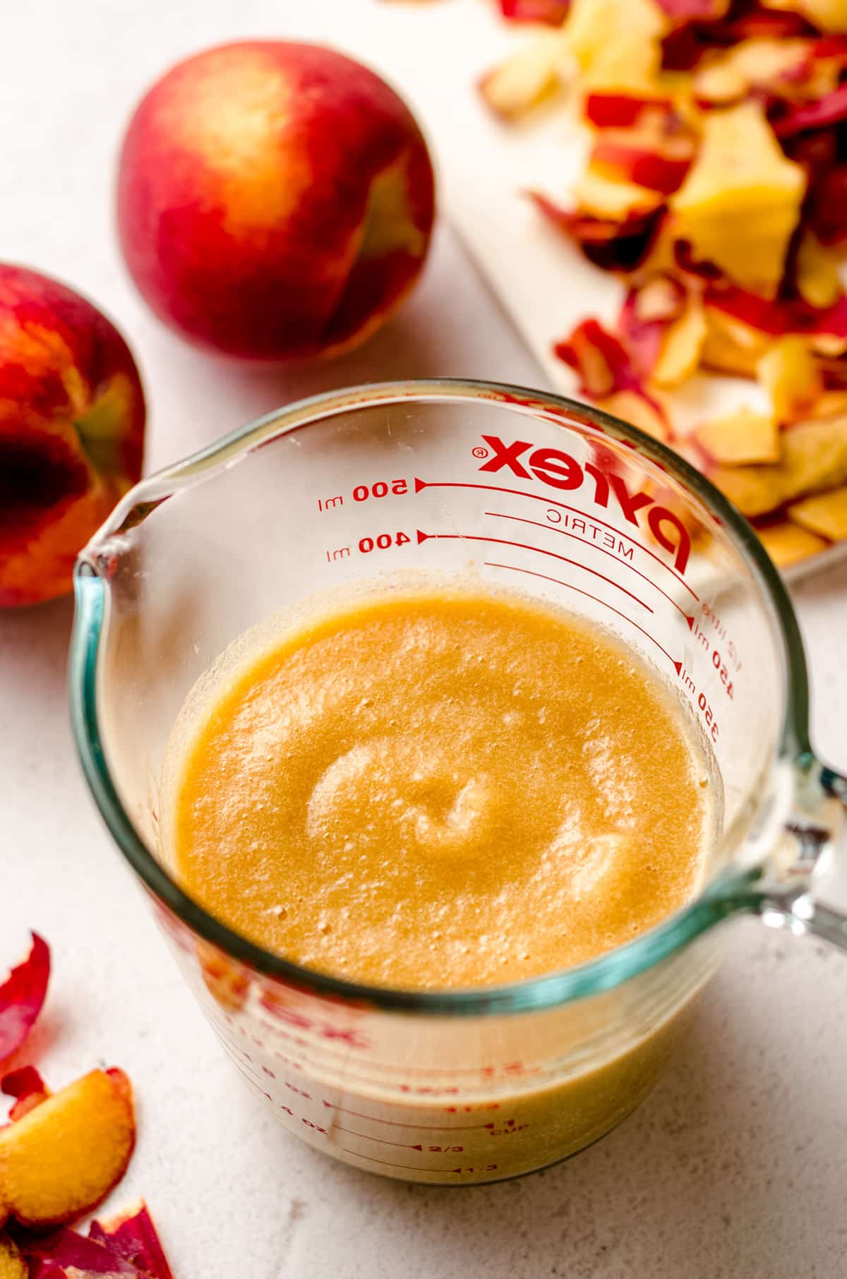 pureed peaches in a glass measuring cup