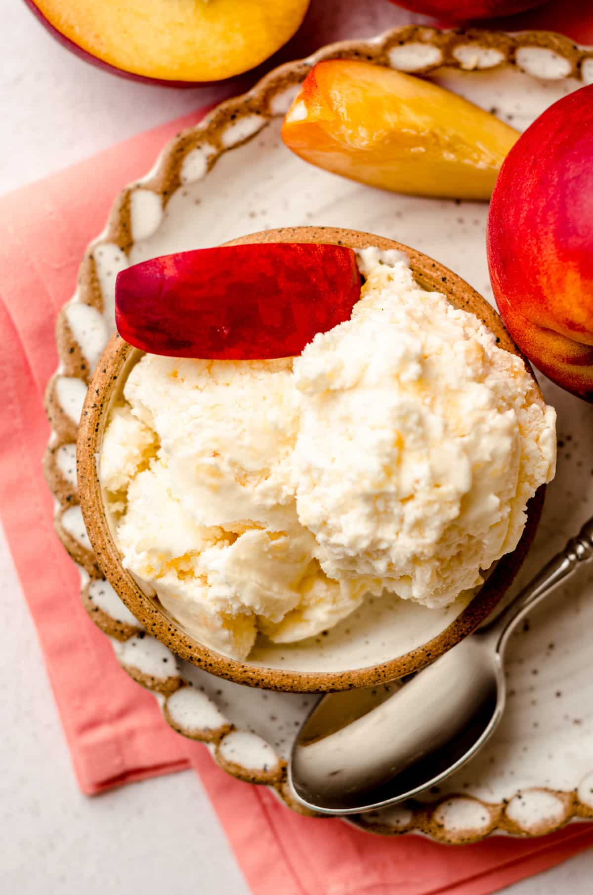 aerial photo of homemade peach ice cream in a bowl with a spoon