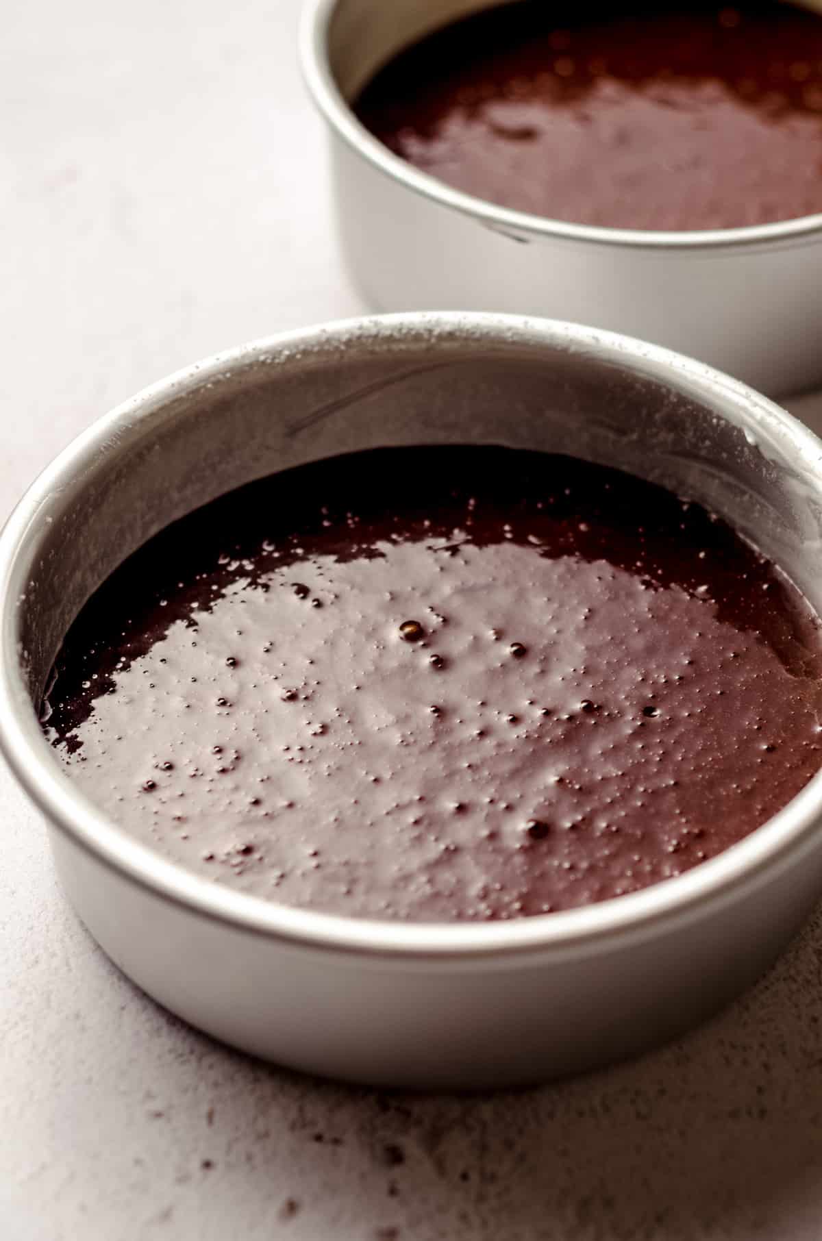 chocolate cake batter in pans