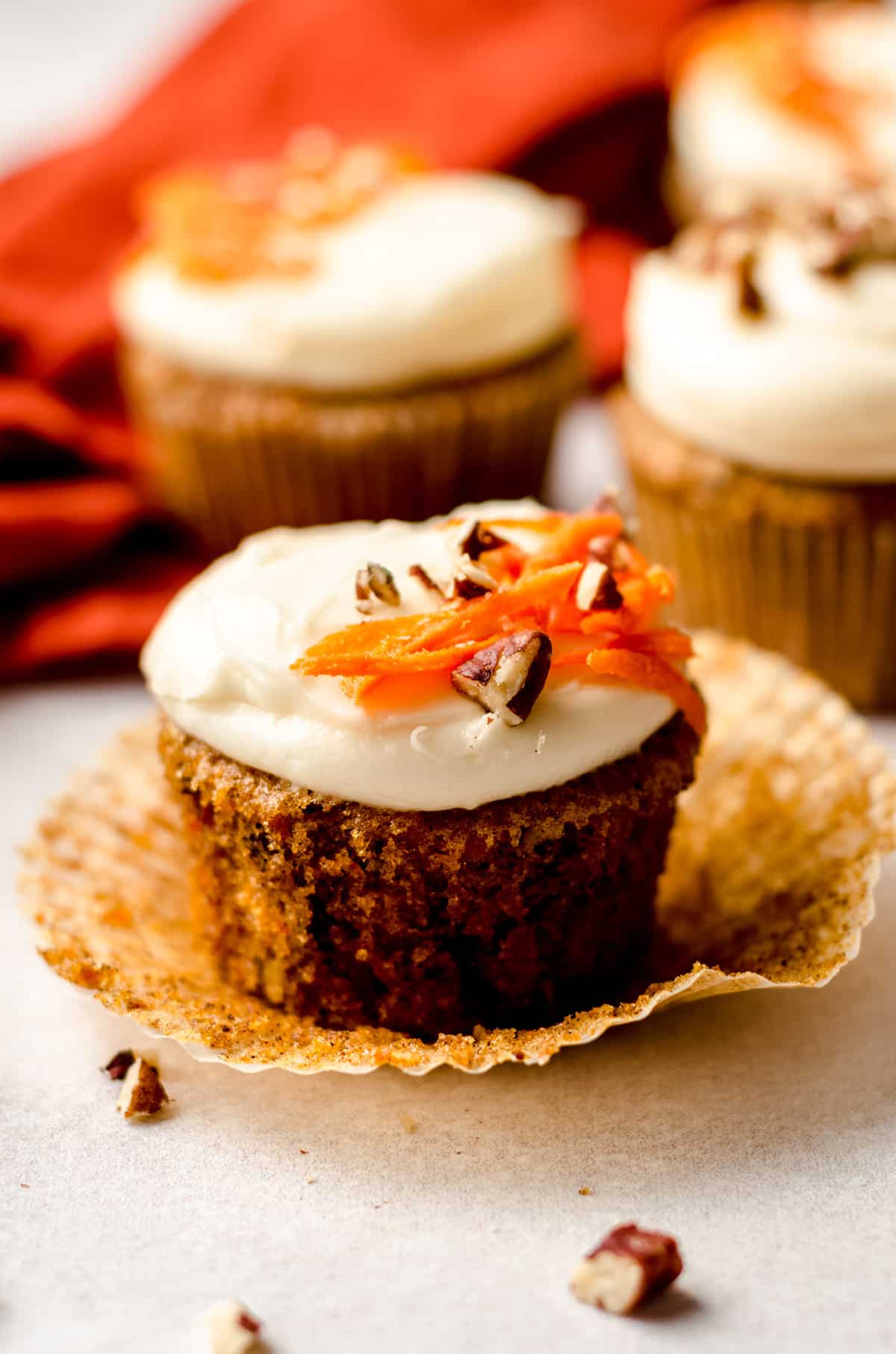 carrot cake cupcakes with cream cheese frosting with the cupcake liner taken off