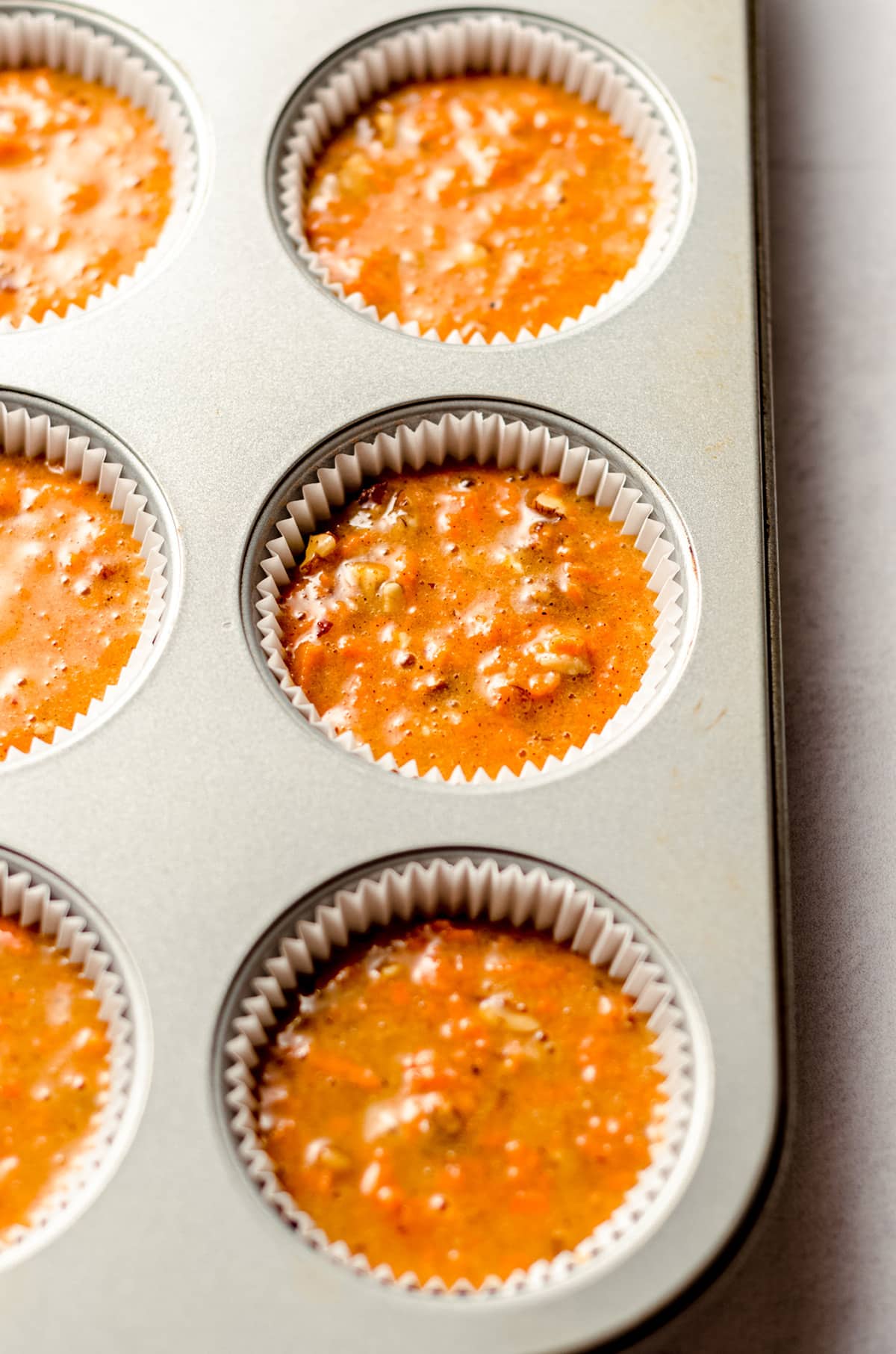 carrot cake cupcake batter in a cupcake pan