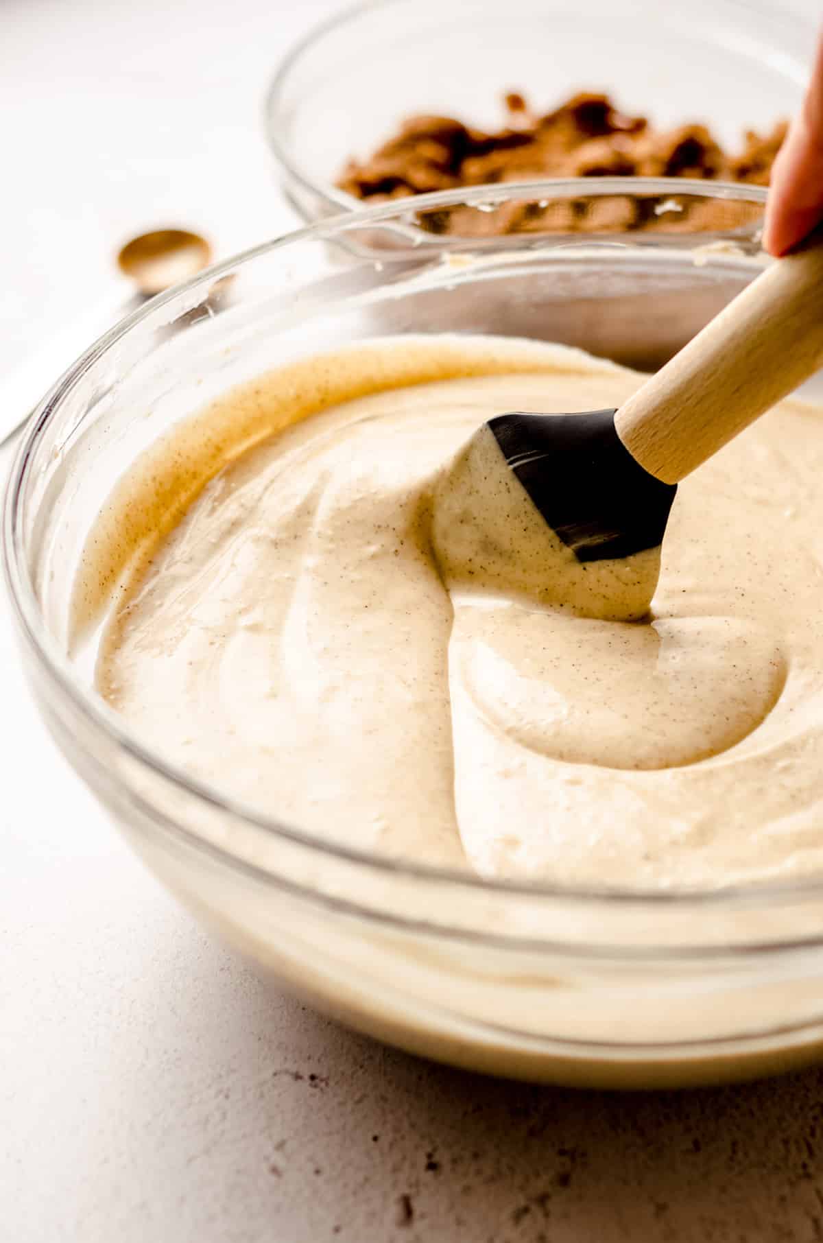 cinnamon roll cheesecake batter in a glass bowl