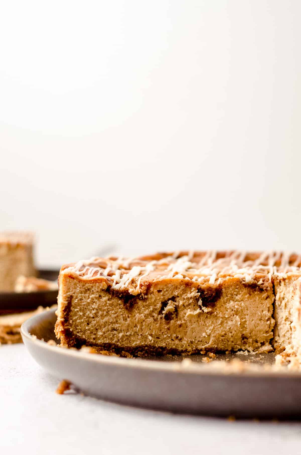 sliced cinnamon roll cheesecake on a plate