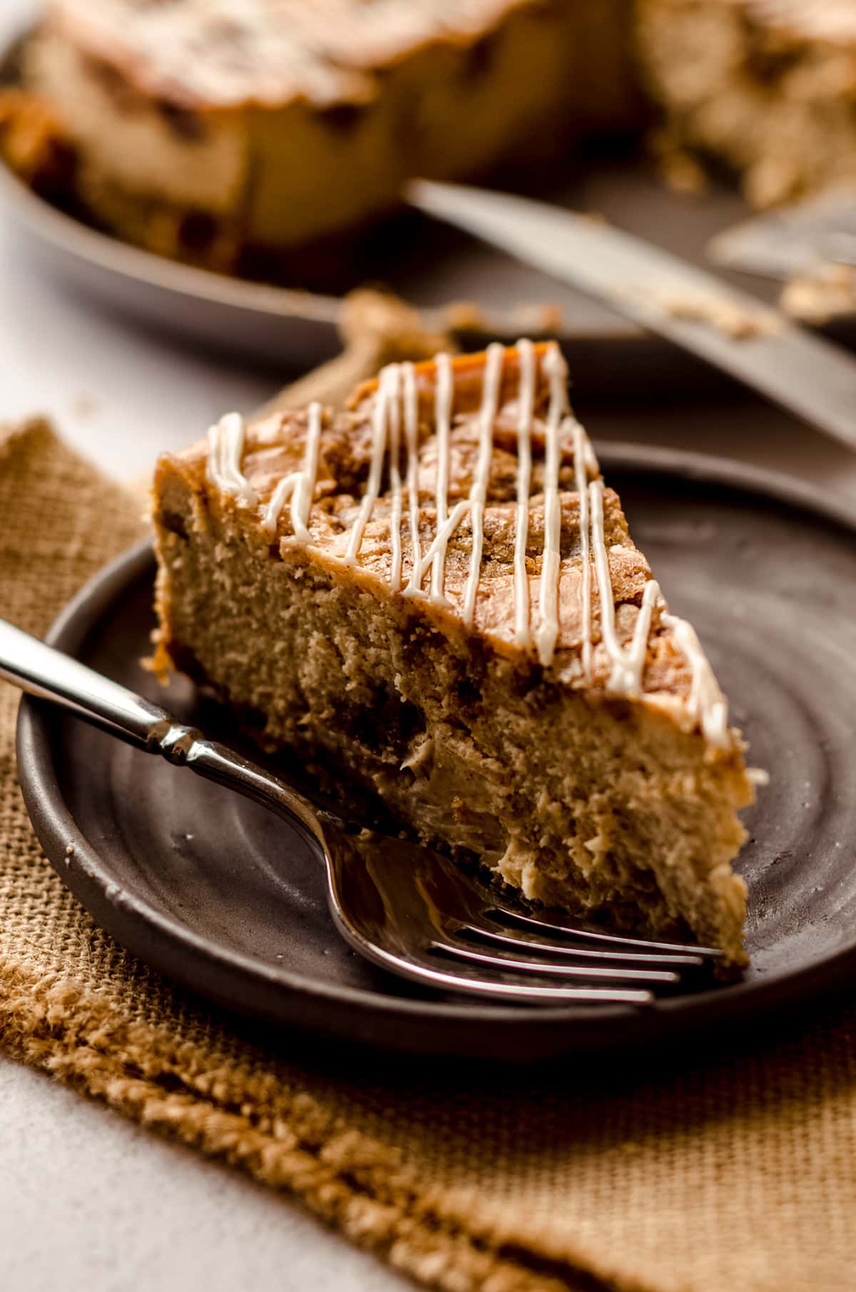 slice of cinnamon roll cheesecake on a plate