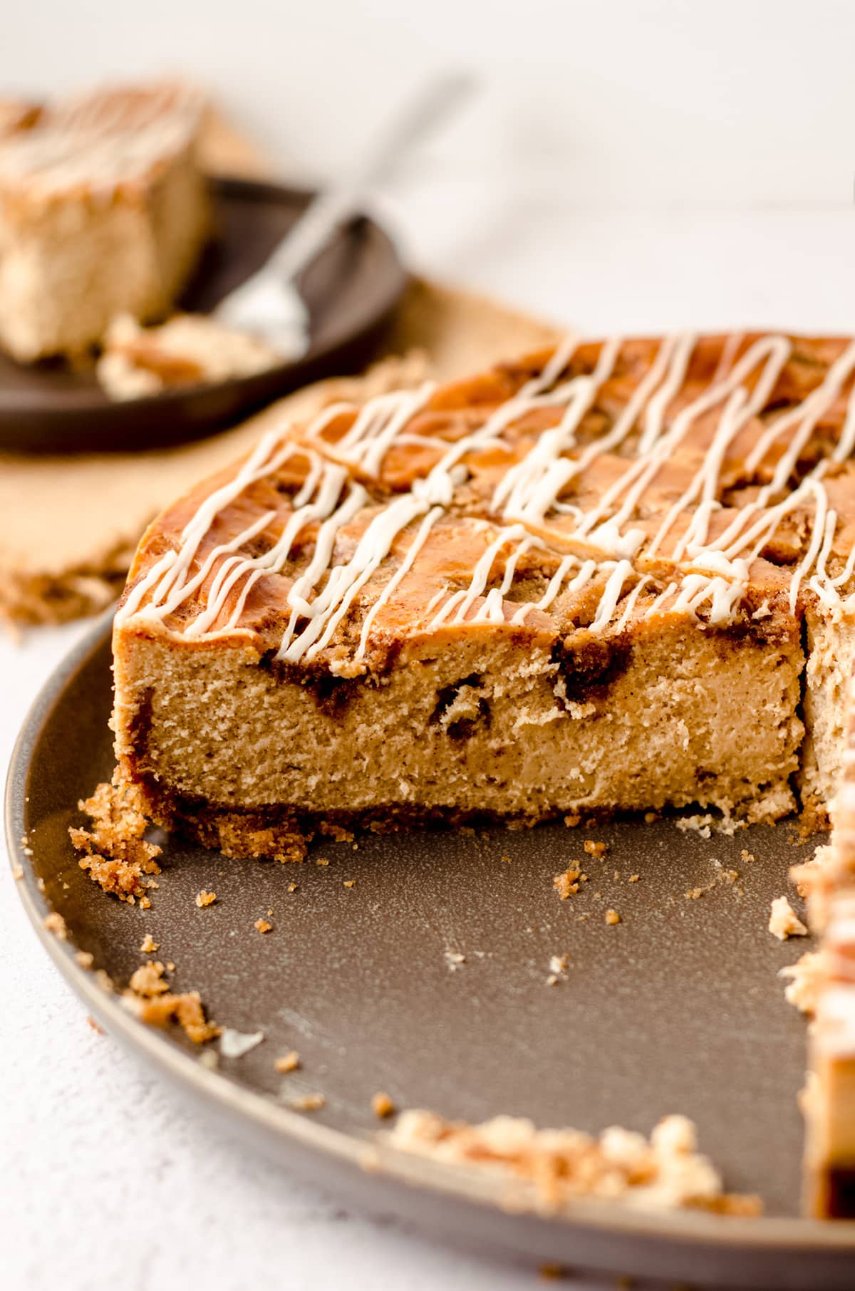 sliced cinnamon roll cheesecake in a springform pan