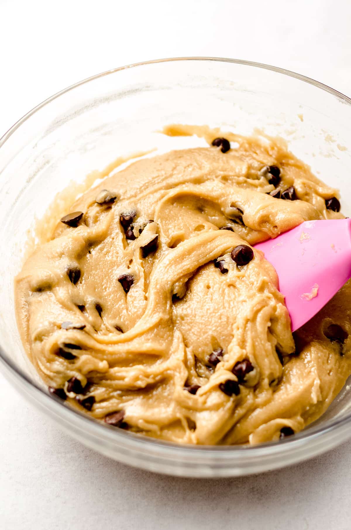 nutella cookie cake dough in a glass bowl with a pink spatula