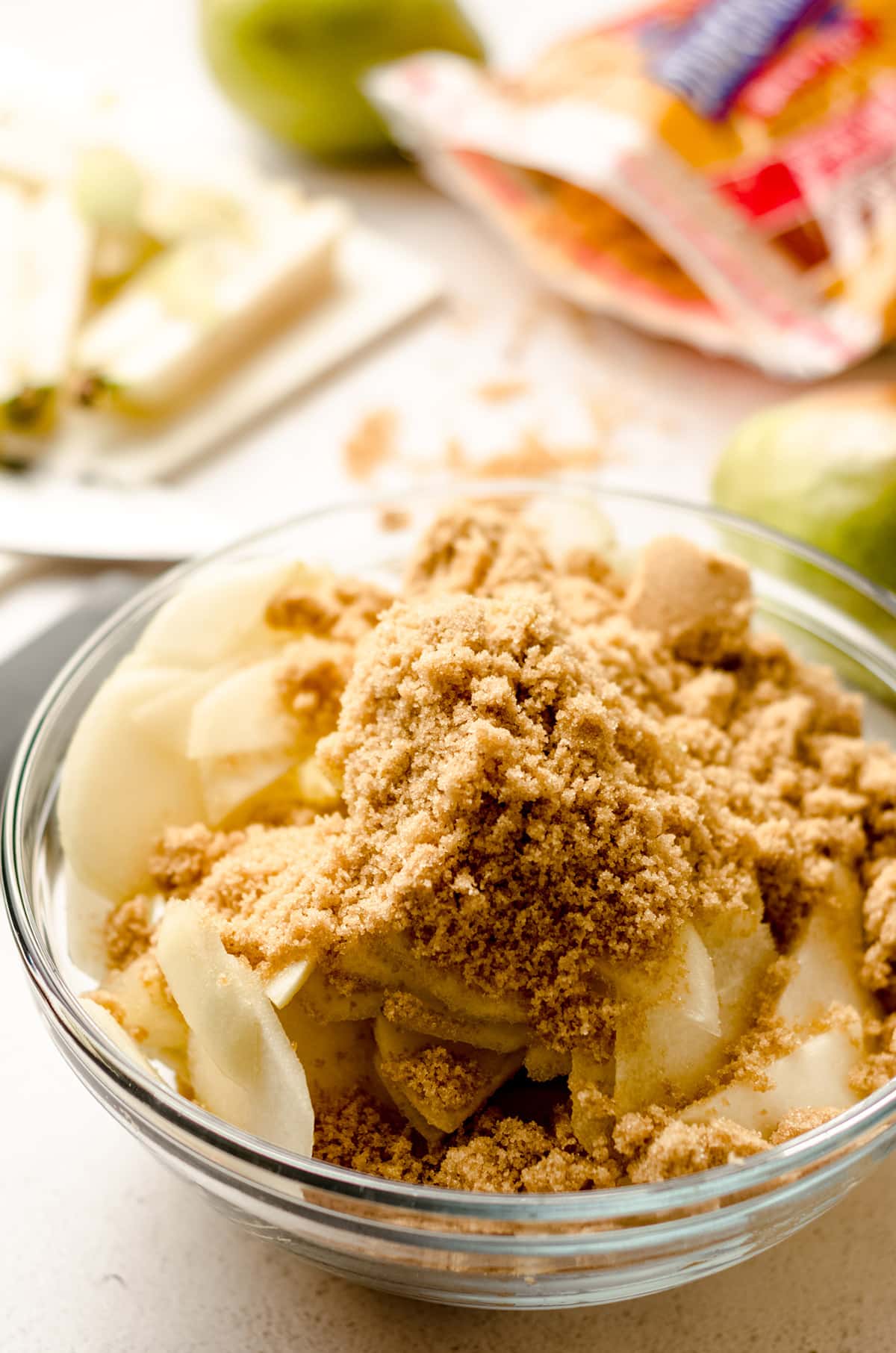 sliced pears in a bowl with cinnamon and brown sugar