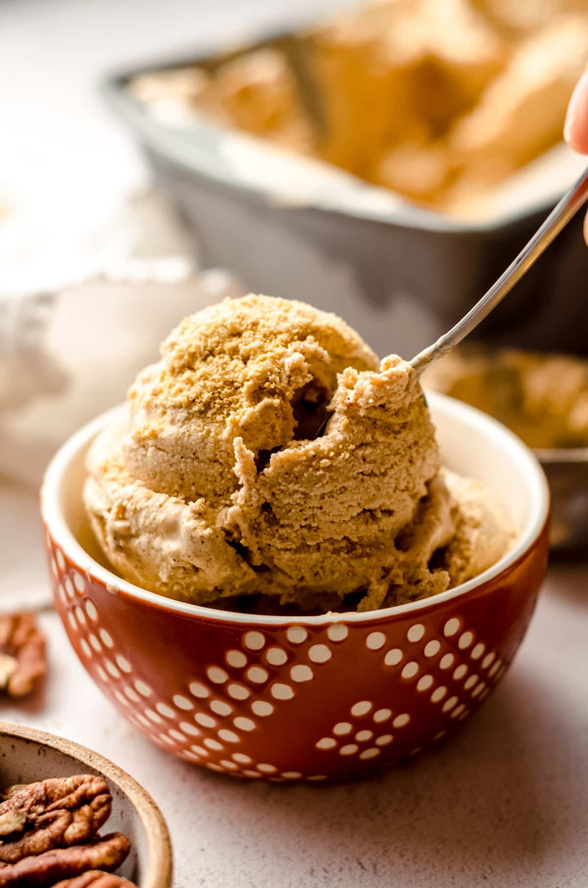 bowl of pumpkin ice cream in a bowl with a spoon