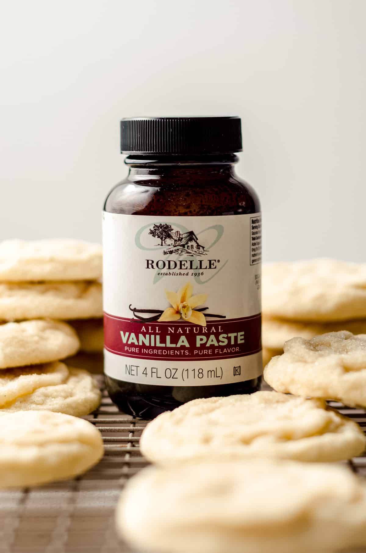 jar of rodelle vanilla paste on a cooling rack with cookies
