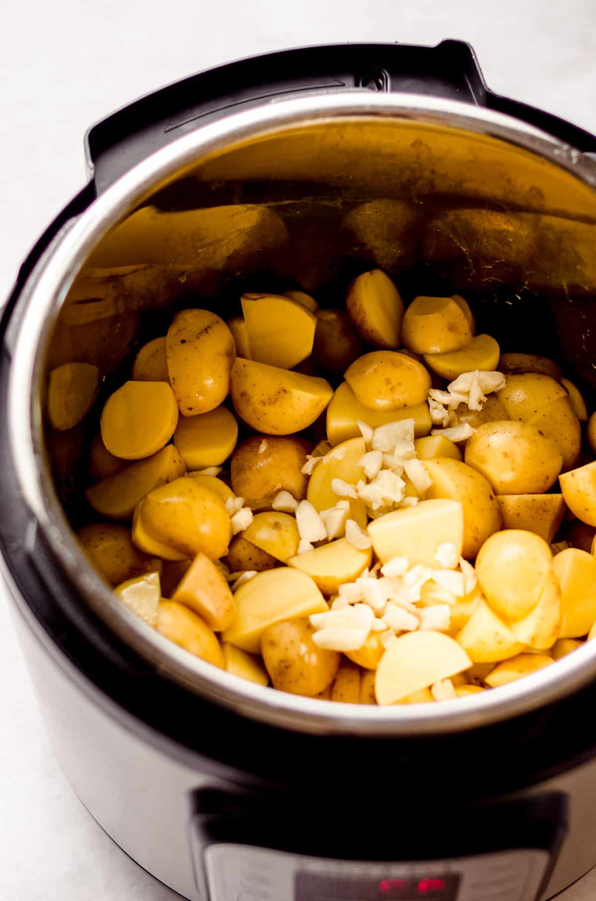 potatoes and garlic in an instant pot ready to make garlic mashed potatoes