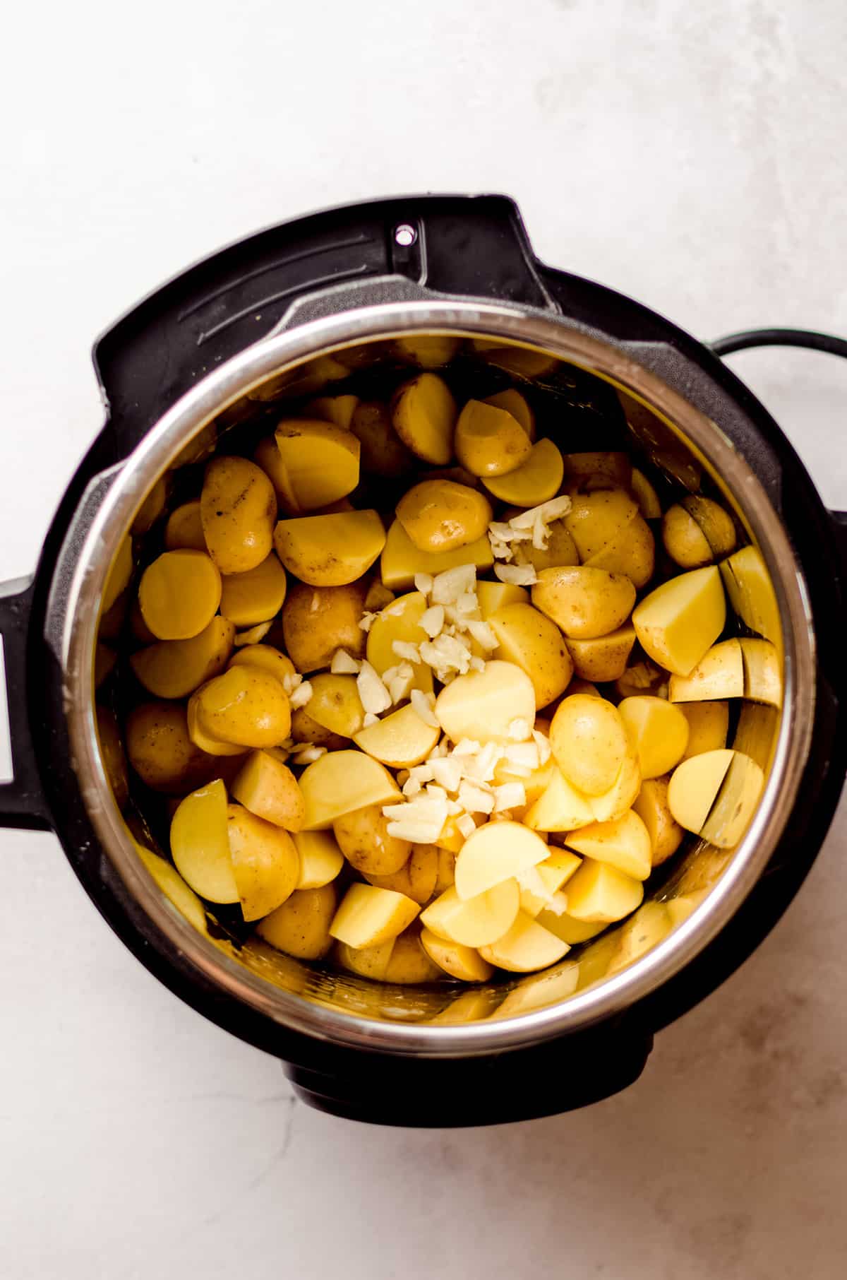 potatoes and garlic in an instant pot ready to make garlic mashed potatoes