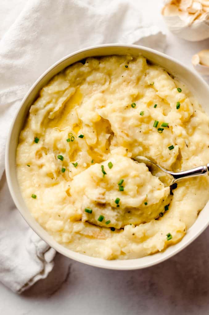 aerial photo of instant pot garlic mashed potatoes in a bowl with a spoon