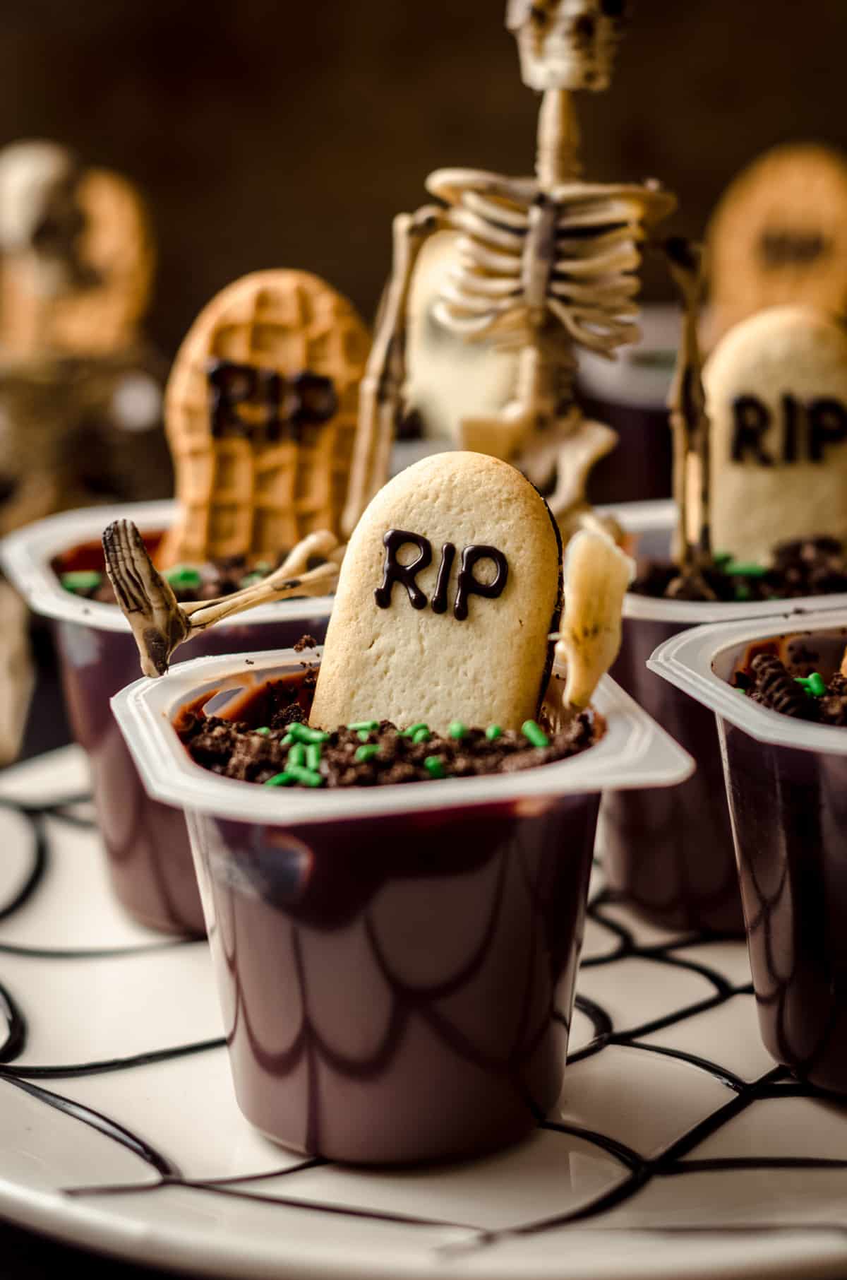graveyard pudding cup with a skeleton sitting on it