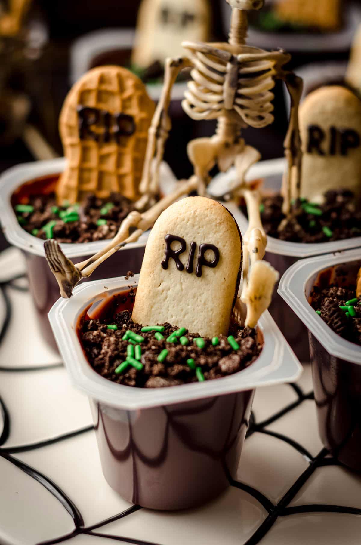 graveyard pudding cup with a skeleton sitting on it
