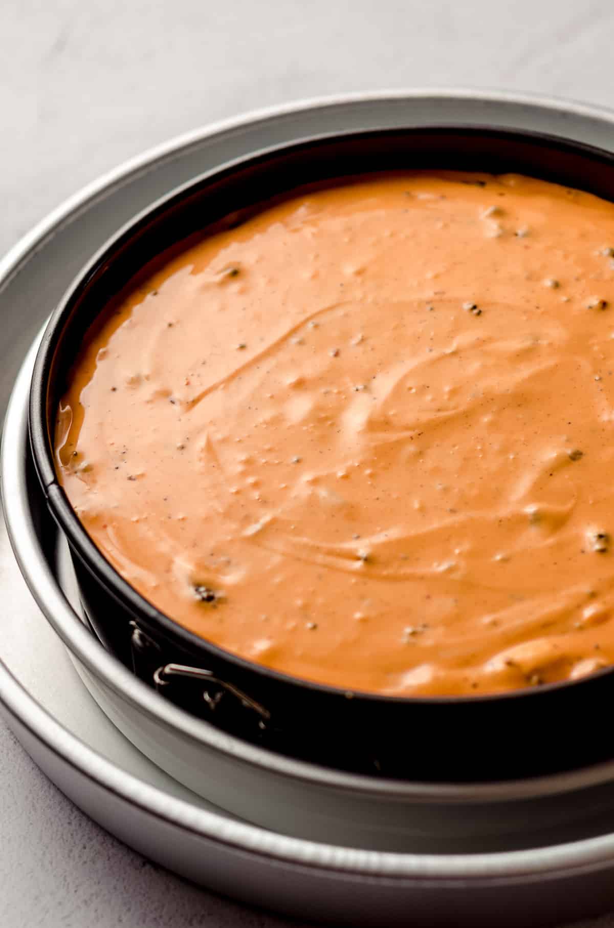 halloween cheesecake batter in a pan